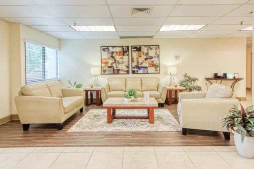 large lobby with comfortable sofas, modern flooring, large windows, and overhead lighting