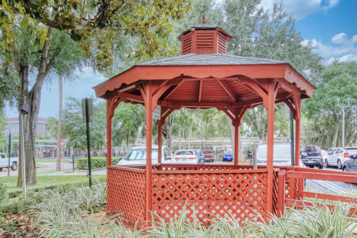 Orlando Cloisters gazebo under large tree and surrounded by lush grasses