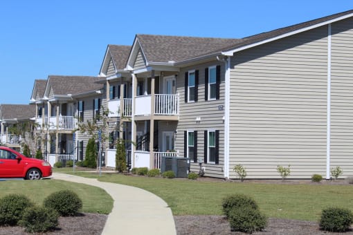 Neatly kept exteriors of Southbrook Apartment Homes buildings with lush landscaping