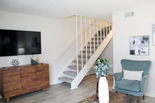 living room with hardwood style flooring and staircase leading upstairs  at Huntsville Landing Apartments, Alabama
