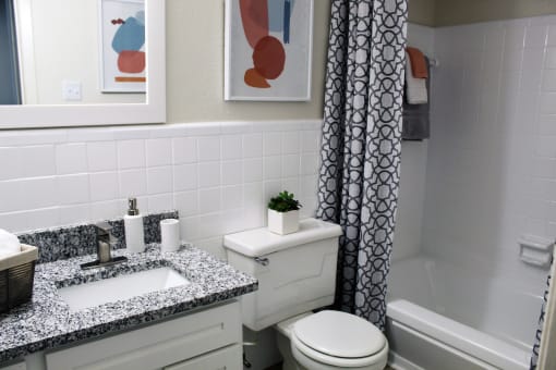 large bathroom with granite vanity, tile, tub, shower, and toilet  at Huntsville Landing Apartments, Huntsville, AL, 35806