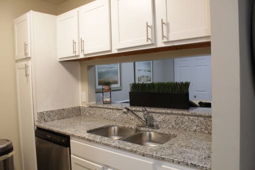 Stillwater apartment kitchen with white cabinets and granite countertops