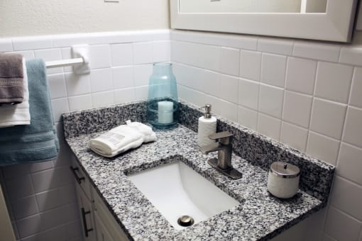 granite vanity in bathroom with under-mount sink, modern fixtures, and tile walls  at Huntsville Landing Apartments, Huntsville, 35806