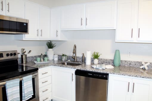 kitchen with white cabinets, granite countertops, and stainless steel appliances  at Huntsville Landing Apartments, Huntsville, 35806