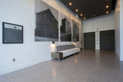 Lobby with elevators, seating, and historic photos at Jemison Flats, Birmingham, 35203