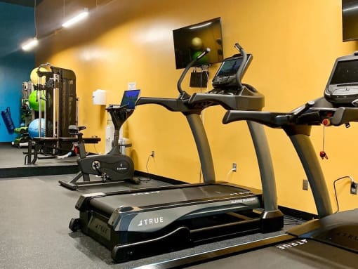 Fitness center with exercise equipment and large mirrors at Jemison Flats, Alabama, 35203
