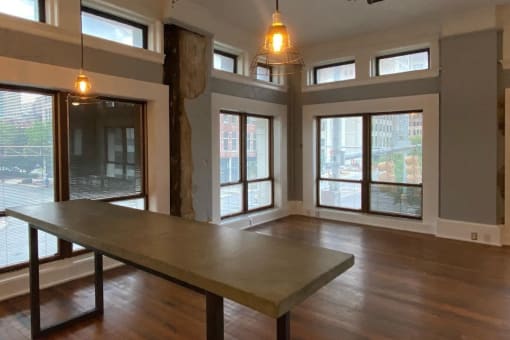 Spacious living area with floor to ceiling windows and hardwood floors at Jemison Flats, Birmingham, AL, 35203