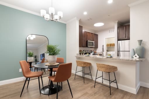 an open kitchen and dining area with a table and chairs