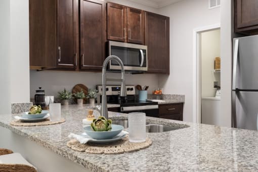 a kitchen with granite counter tops and stainless steel appliances
