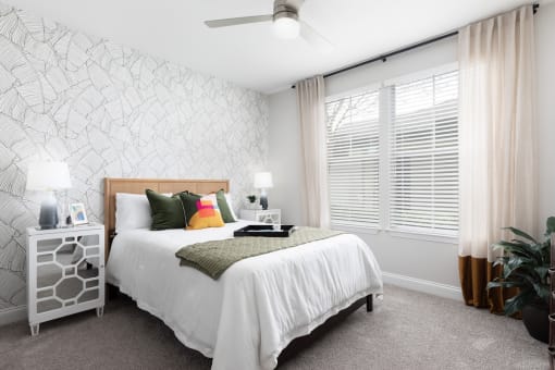 a bedroom with a bed and a large window
