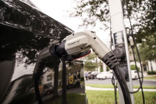 Electric car charger plugged into car at Lake Nona Water Mark in Orlando, FL 32827