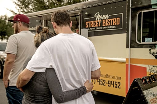 People standing in line at a food truck near Lake Nona Water Mark Apartments