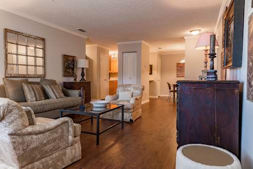 A living room with a couch, chair, and coffee table.