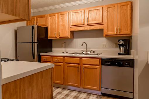 A kitchen with wooden cabinets and stainless steel appliances.