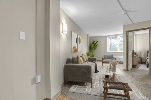 the living room of an apartment with a couch and chairs