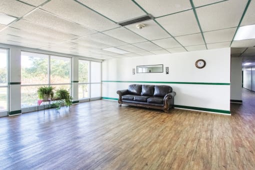 lobby with large windows and a couch for sitting