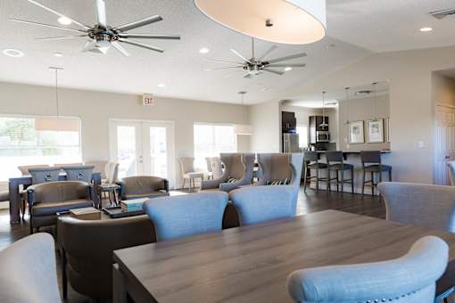 A spacious room with a long table and chairs.