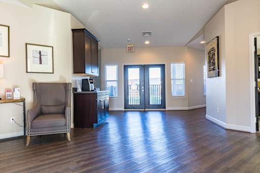 A living room with a chair and a cabinet.