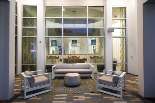 Sitting area with chairs and couch outside of the game lounge at Residences at The Green