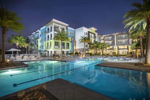 Luxury, resort-style, olympic-sized pool at night at Residences at The Green Apartments for rent