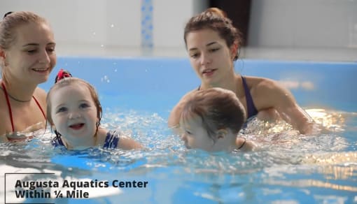 a family playing in the water in a swimming pool