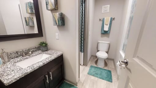 Bathroom with granite vanity, mirror, toilet, and tub at The Madison Franklin, Tennessee, 37064