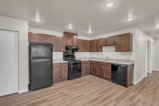a kitchen with wooden cabinets and black appliances