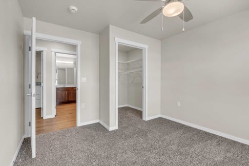 a bedroom with a closet and a ceiling fan