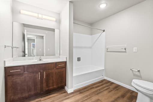 a bathroom with a toilet and a sink and a mirror
