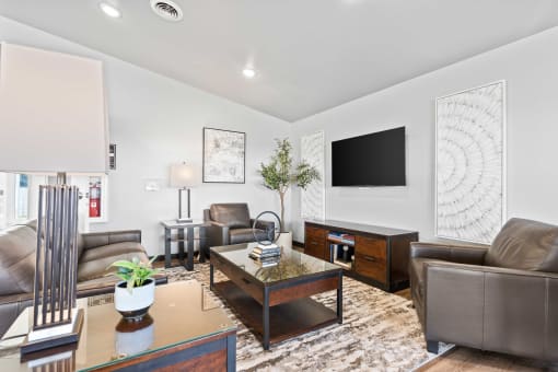 a living room with leather furniture and a television