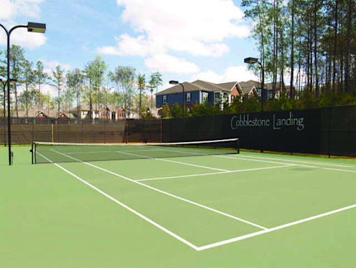 A tennis court with a net and a sign that says Cobbstone Landing.