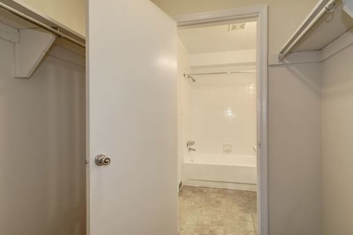 a bathroom with a white bathtub and a white door