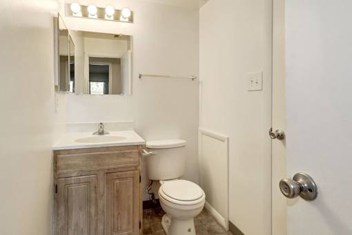 a bathroom with a toilet sink and mirror