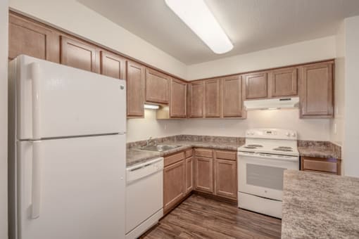 a kitchen with wooden cabinets and white appliances