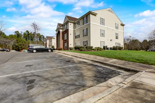 an empty parking lot in front of an apartment building