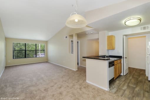 Living room with carpet flooring and kitchen breakfast bar