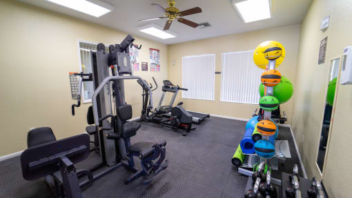 Fitness center equipped with strength training equipment, cardio equipment, and yoga equipment