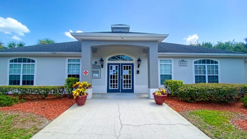 A white building with a blue door and windows.