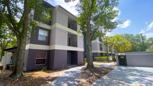 Apartment building exterior surrounded by native landscaping