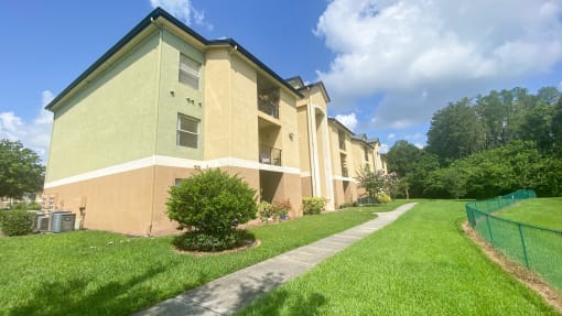 Apartment building exterior surrounded by native landscaping