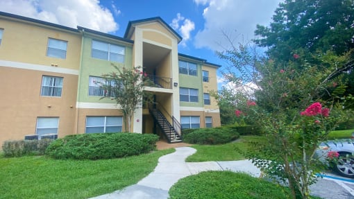 Apartment building exterior surrounded by native landscaping
