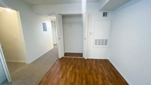 Dining Room with wood floors, white walls, and coat closet