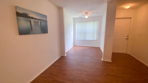 Spacious floor plan with hardwood style flooring and multi speed ceiling fan
