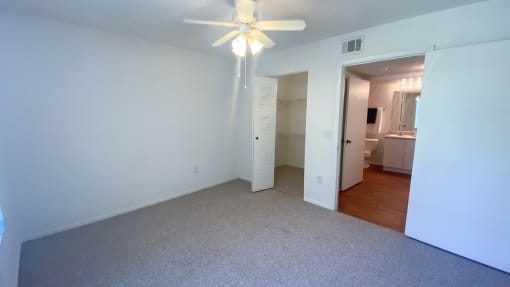Spacious Bedroom with walk-in closet, in-suite bathroom, and multi speed ceiling fan