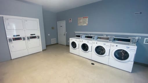 Resident clothing care center with washers, dryers, and tiled flooring