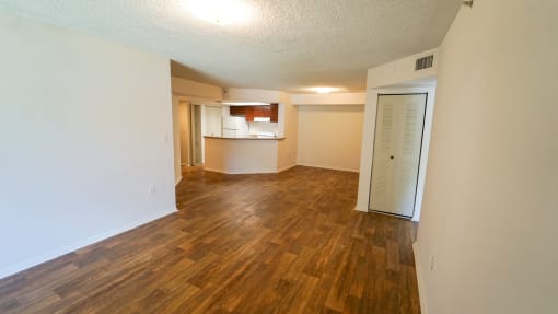 Open Floor Plan with Hardwood Style Flooring and Breakfast Bar off of Kitchen