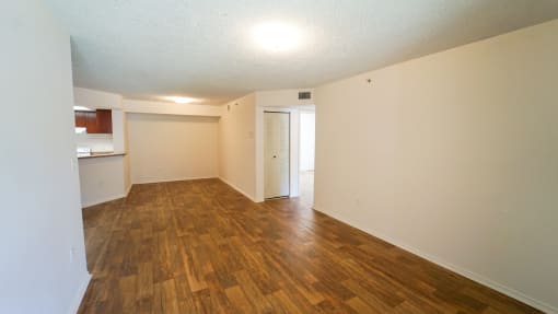 Open Floor Plan with Hardwood Style Flooring and Breakfast Bar off of Kitchen
