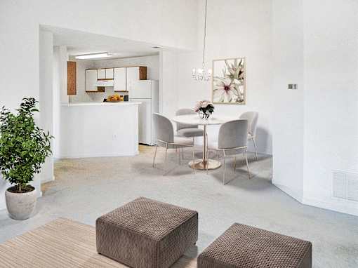 A white room with a dining table and chairs.