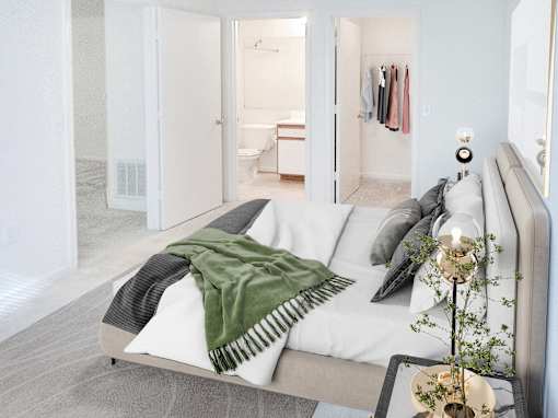A modern living room with a grey sofa and a green throw.
