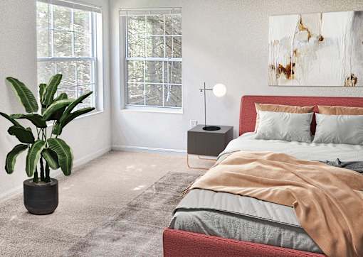 A bedroom with a bed, a plant, and a painting on the wall.